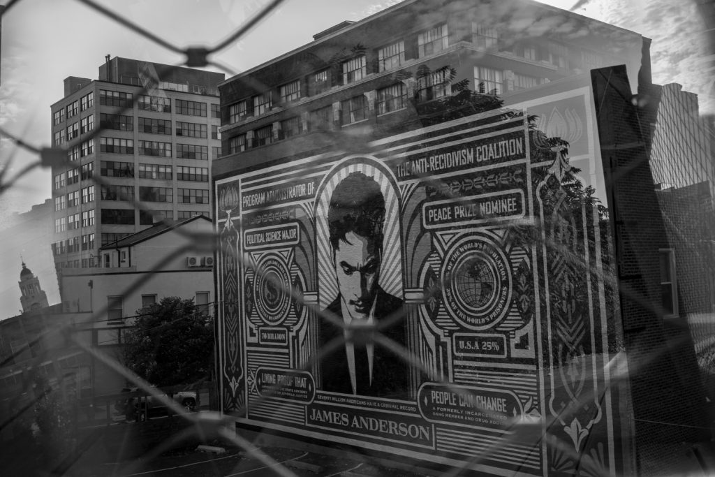 Black and white prism photo of the stamp of incarceration project mural in Philadelphia's Rail Park 